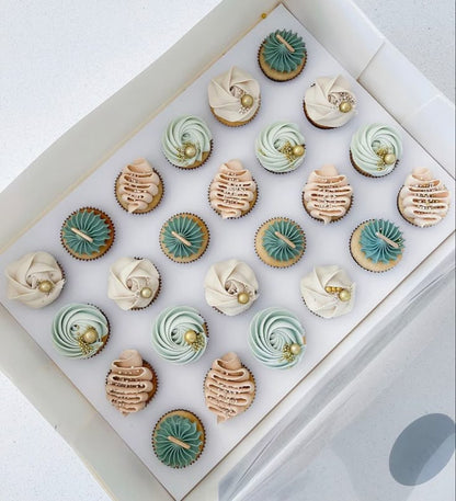 Assorted cupcakes in a box with various colors and designs.